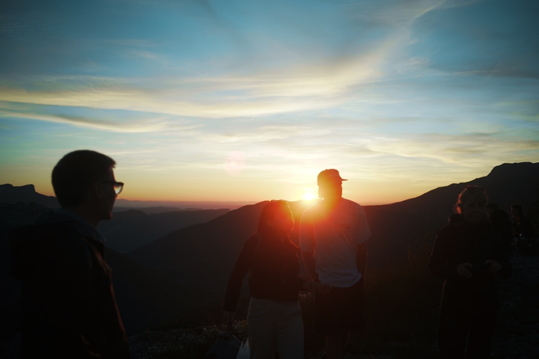 夕焼けの山に浮かぶ人々のシルエット