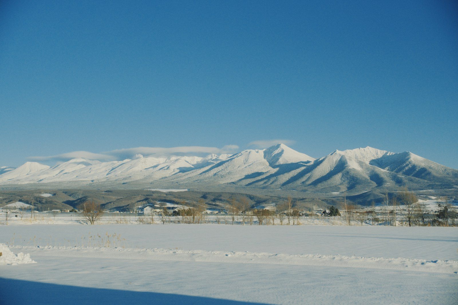 青空の下に連なる北海道の雪山